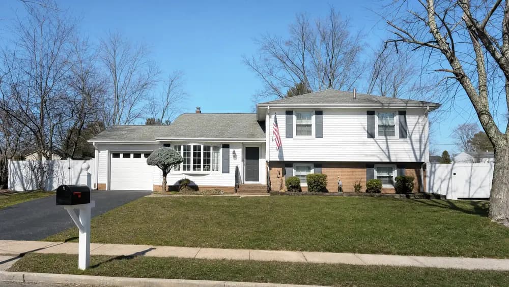 Homeowner reviewing overdue property tax notices at kitchen table, behind on property taxes in New Jersey
