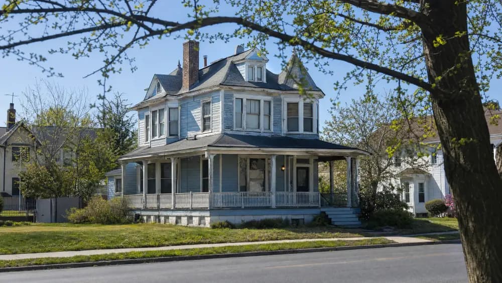 Executor reviewing NJ probate court documents next to a vacant inherited house, illustrating the NJ probate timeline for