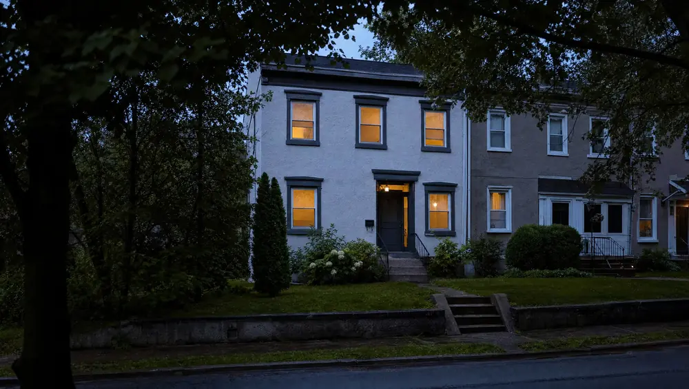 New Jersey homeowner reviewing pre-foreclosure options at kitchen table with foreclosure notice documents