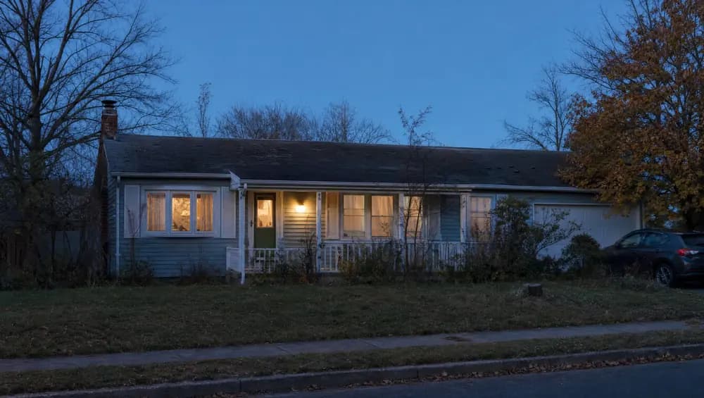 New Jersey homeowner loading moving boxes while relocating on a deadline, front door open and house listed for fast cash sale