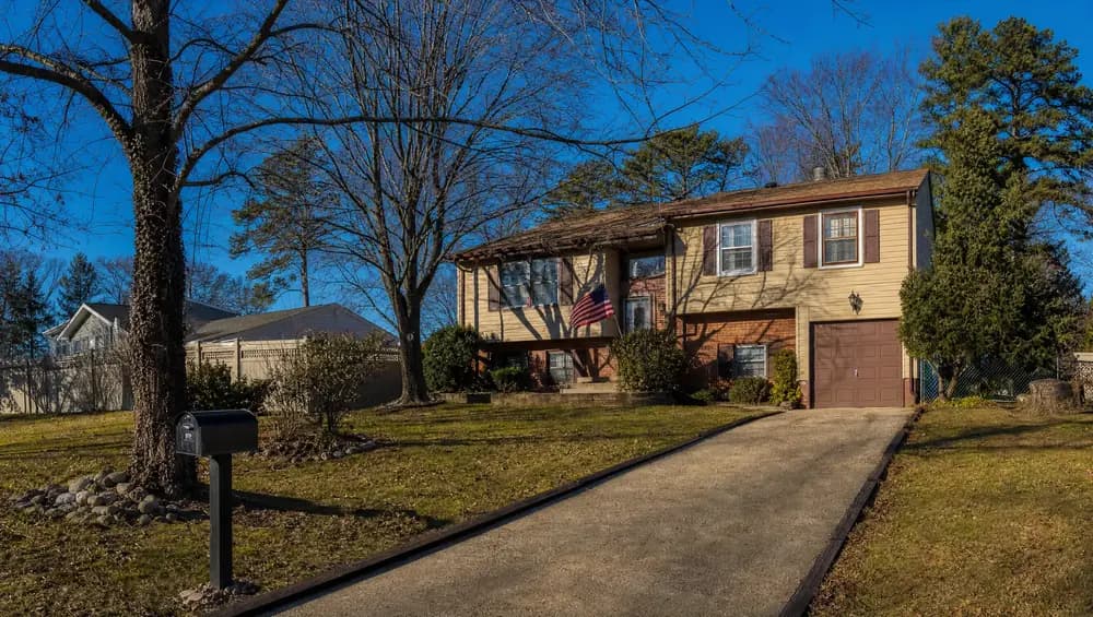 Exterior of a fire-damaged home in New Jersey with a sold sign. Sell a damaged house as-is in NJ for cash