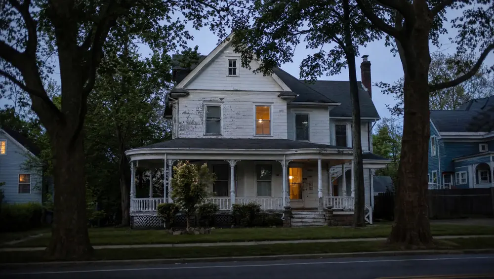 NJ inherited house exterior with tax documents on table illustrating stepped-up basis and capital gains concepts