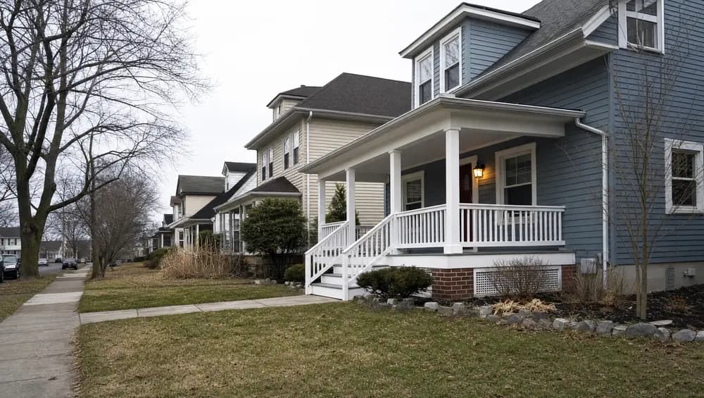 NJ landlord reviewing rental sale taxes depreciation recapture and 1031 exchange documents at kitchen table